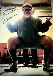 Doug Holland performing a barbell squat.